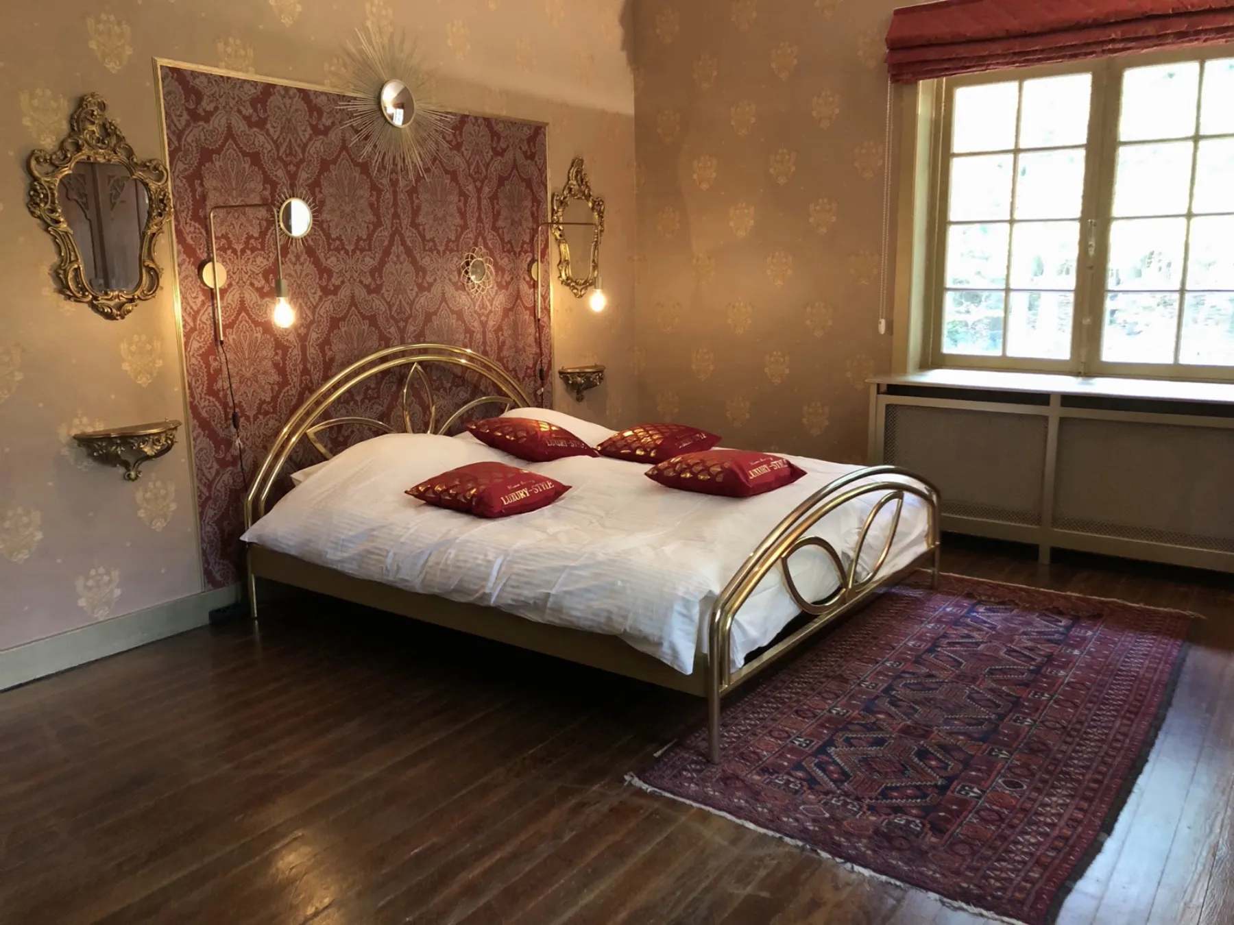 Rouge et Or bedroom with brass bed